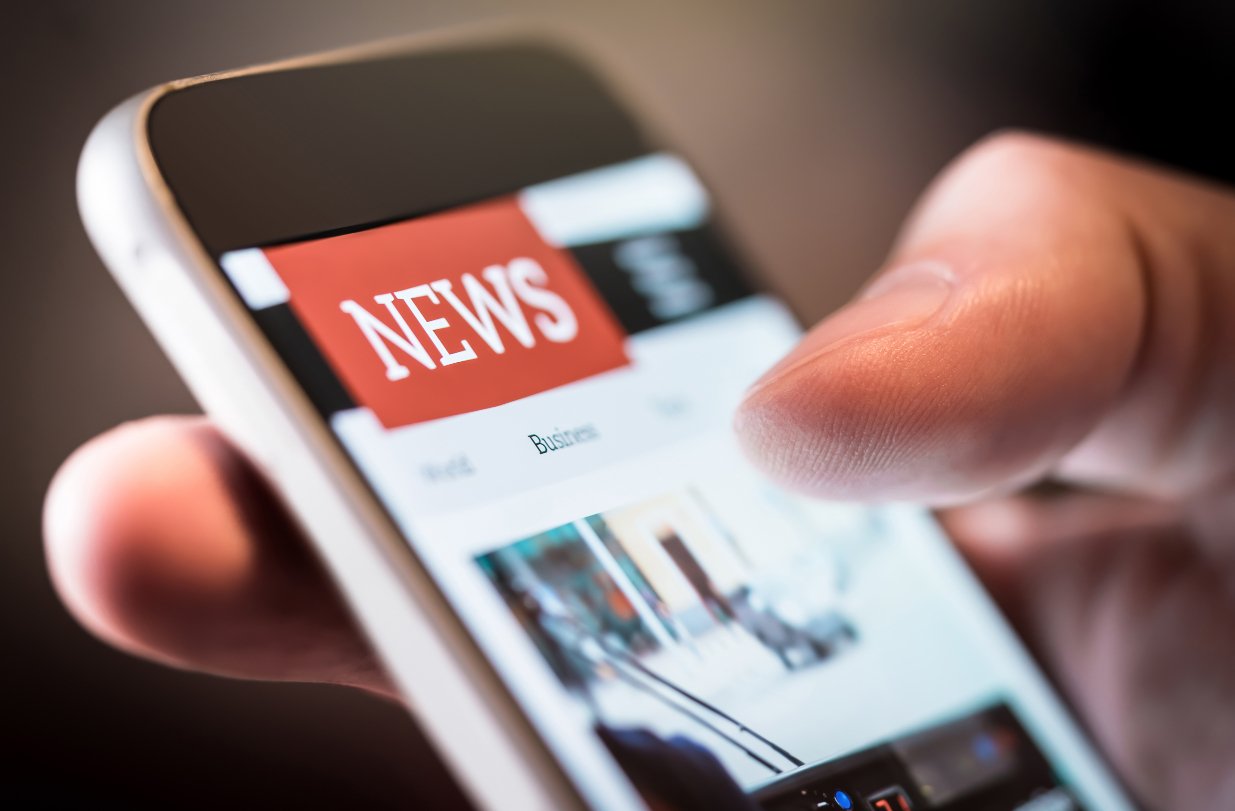 News report on a mobile phone screen